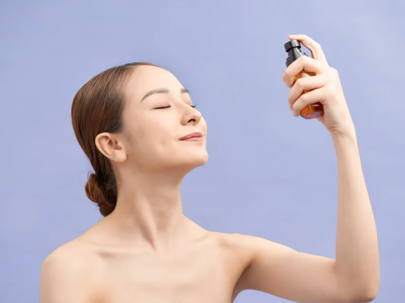 A woman using a face mist