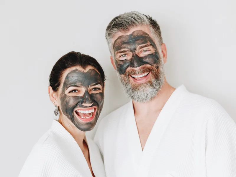 A woman and man wearing a face sheet mask