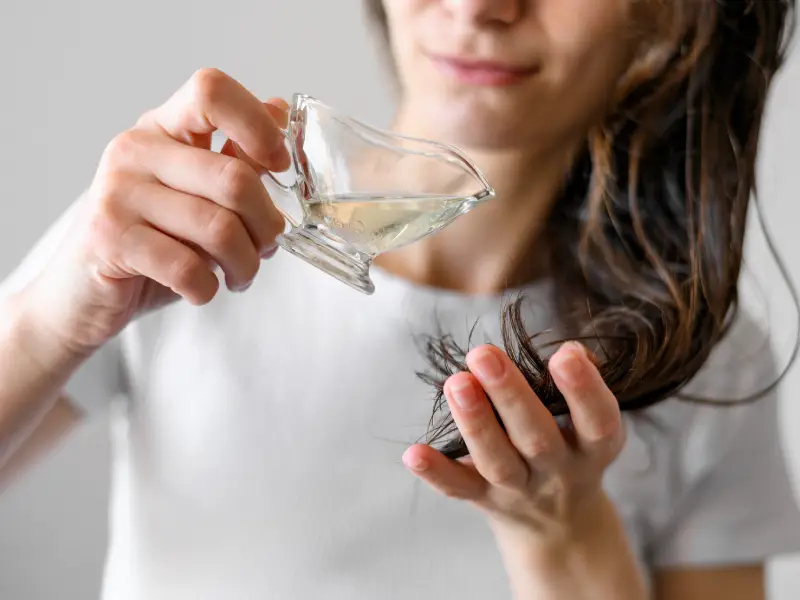 a woman applying a home remedie for dandruff