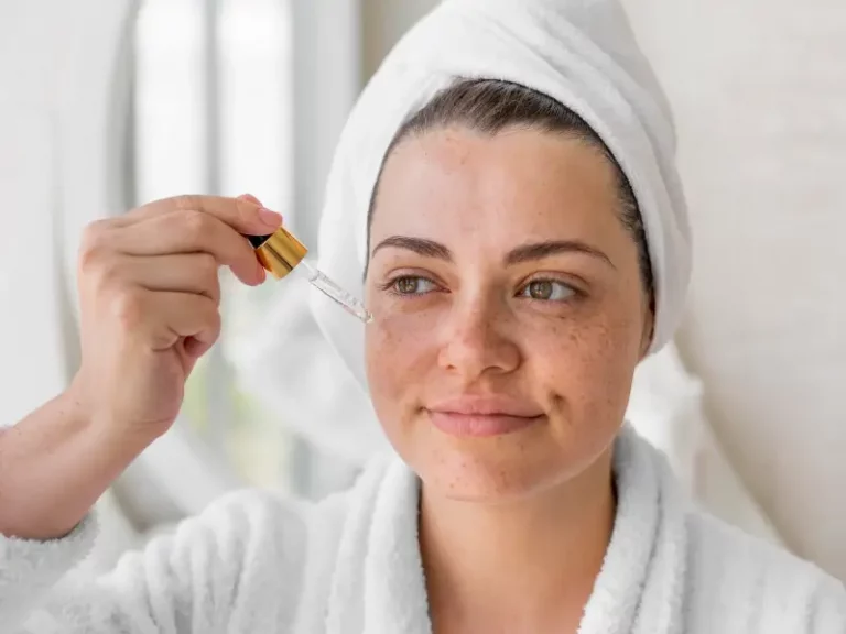 a woman applying a rosacea serum