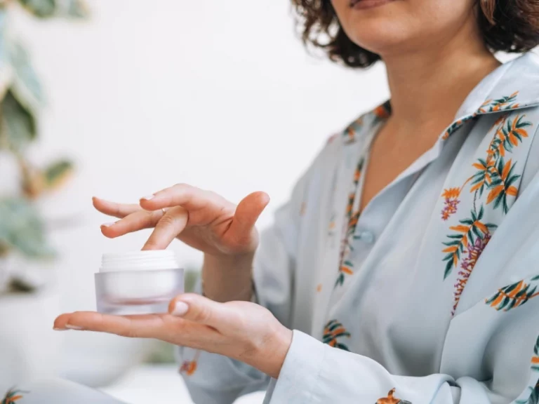 a woman applying a neck cream